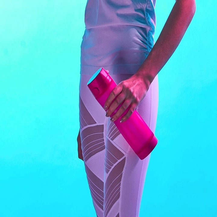 Model holding pink water smart water bottle