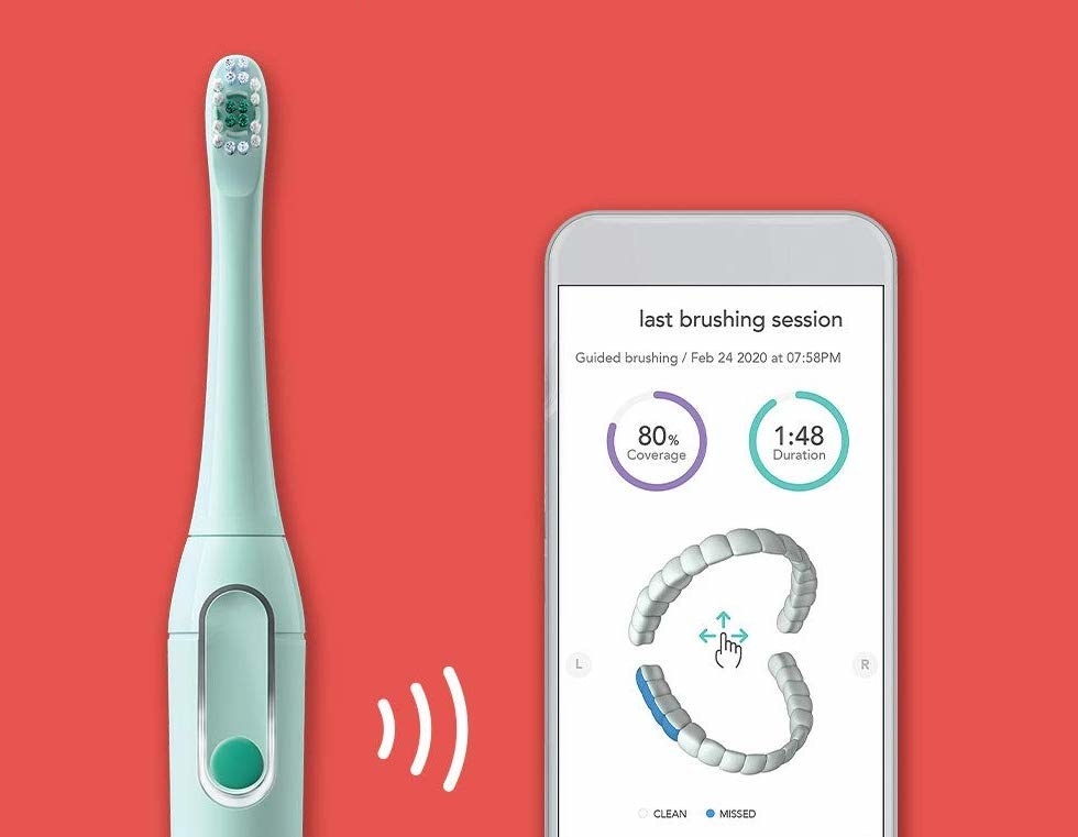 Colgate Hum toothbrush next to smartphone with the accompanying app