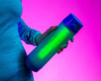 Model holding glowing smart water bottle 