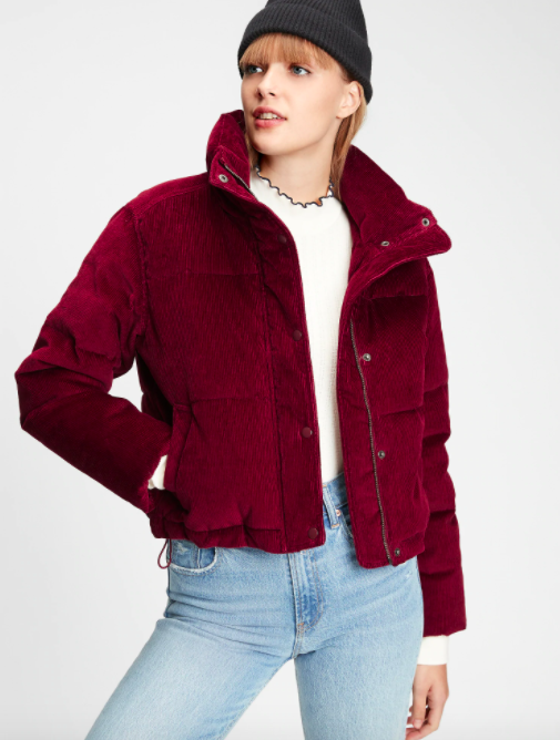 A person wearing the corduroy puffer with a pair of high waisted jeans