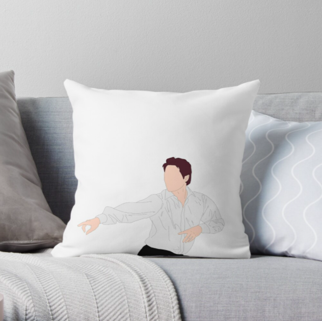 The square white pillow with a silhouette of Hugh Grant in "Love, Actually" pointing his fingers and dancing