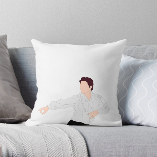 The square white pillow with a silhouette of Hugh Grant in &quot;Love, Actually&quot; pointing his fingers and dancing