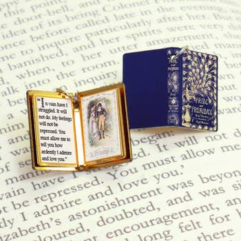 pride and prejudice book charm with blue cover with a peacock 