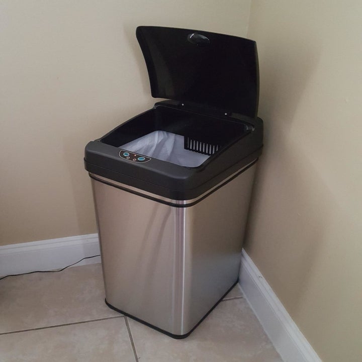Trash can with automatic lid open