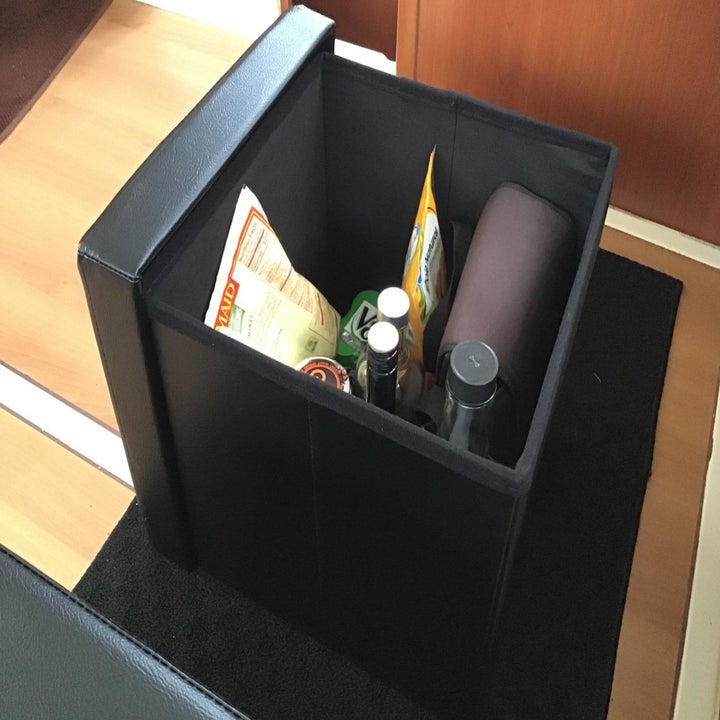 reviewer image of snacks inside of one of those ottomans