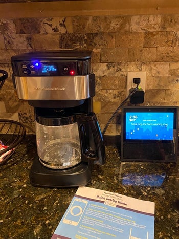 Reviewer photo of coffee maker on kitchen counter next to an Alexa-enabled device