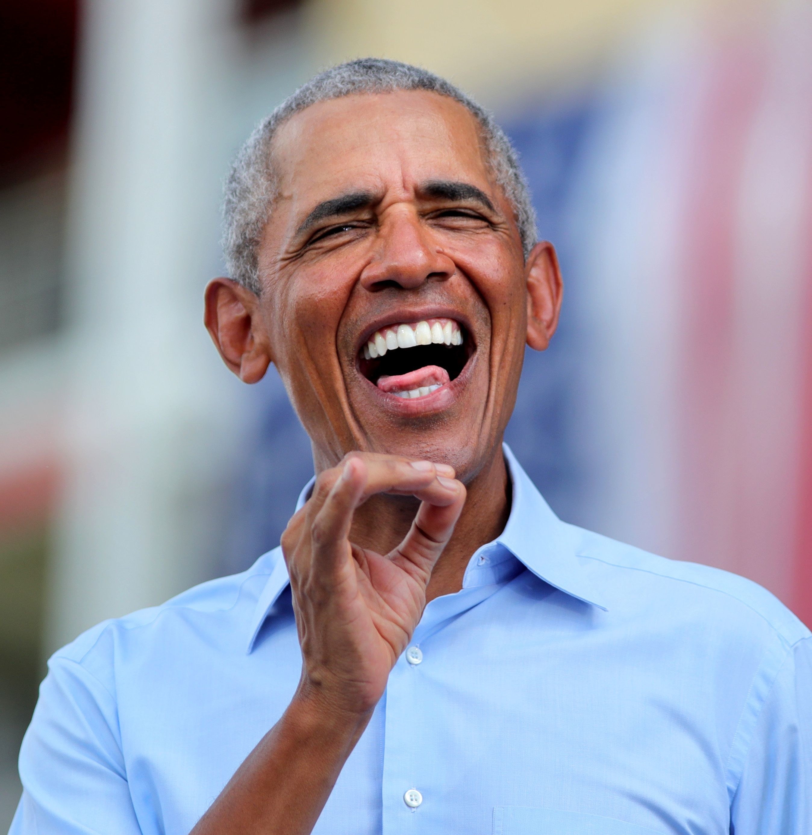 Former president Barack Obama responds to cheering supporters as he takes the stage in Orlando at a drive-in rally