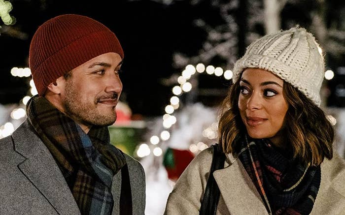 Amber Stevens and Marco Grazzini, dressed in winter clothes, smile at each other