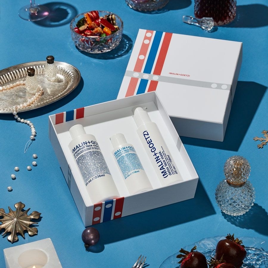 the skincare set styled on a table with holiday decor