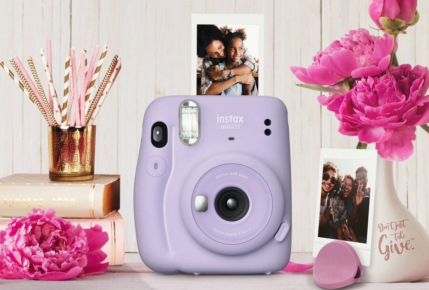 The Fuji Instax Mini in purple surrounded by pictures it has taken