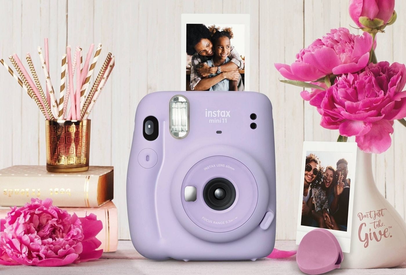 The Fuji Instax Mini in purple surrounded by pictures it has taken