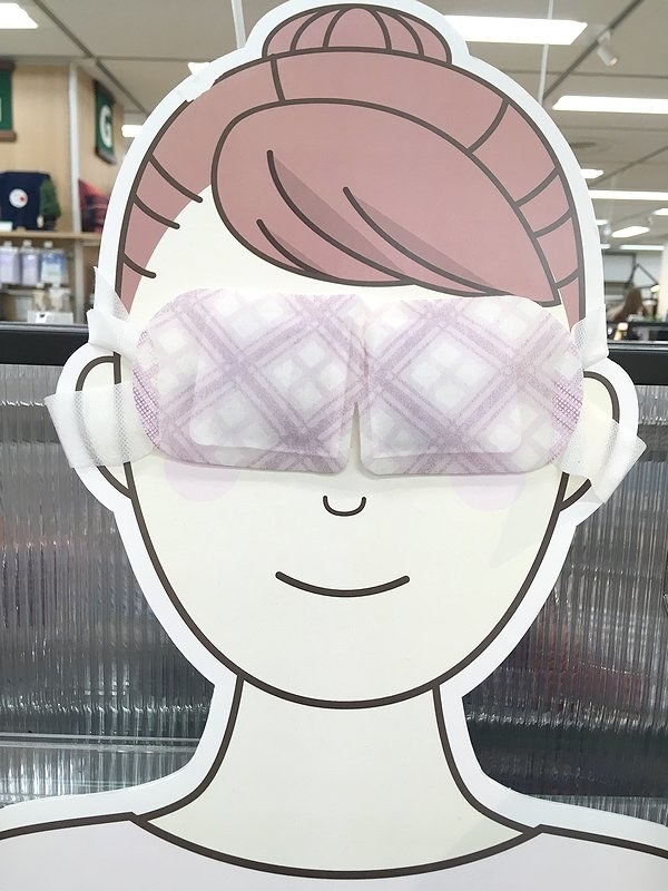 a cardboard cut out of a face wearing a padded eye mask 