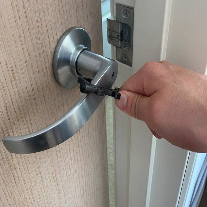 a person using the tool to open a door
