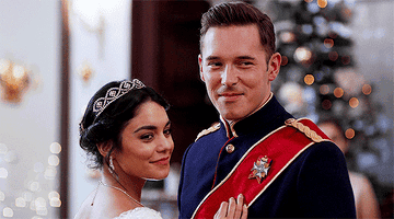GIF of Vanessa winking as she stands with her prince in The Princess Switch