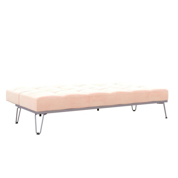The couch, folded flat, still elevated slightly off the ground on small metal legs