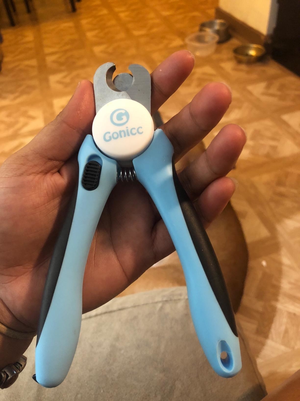 Reviewer image holding lightweight clippers with safety guard