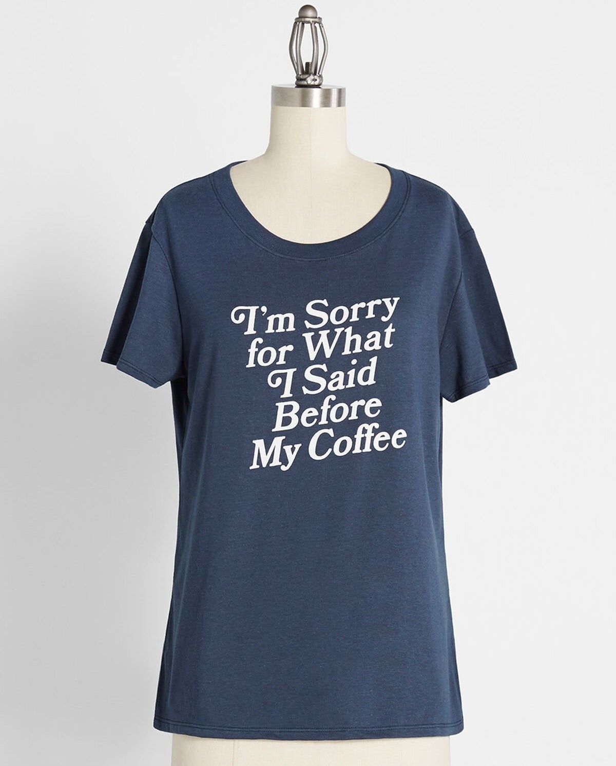 the blue shirt that reads "i'm sorry for what I said before my coffee" in white text