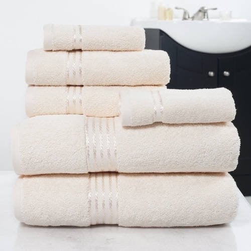 the towels in white displayed in a bathroom 