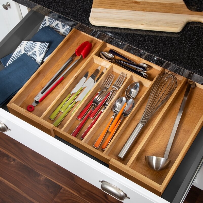 The bamboo drawer organizer expanded to reveal two large compartments
