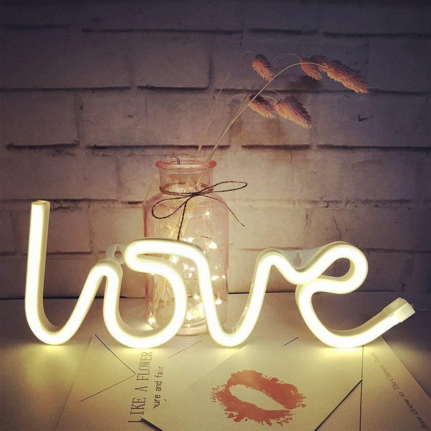 A white neon lamp that spells &quot;Love&quot;.