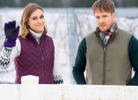 Julianna Guill and Jon Corr stand side by side in a snow-covered vineyard
