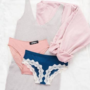 two pairs of underwear, one pink, the other blue with lace trim