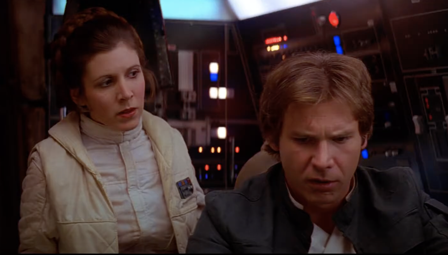 Fisher as Princess Leia looks at Ford as Solo, who looks confused