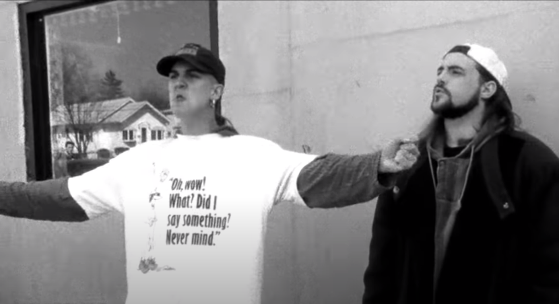 Mewes as Jay pontificates with hands outstretched in front of the mini mart