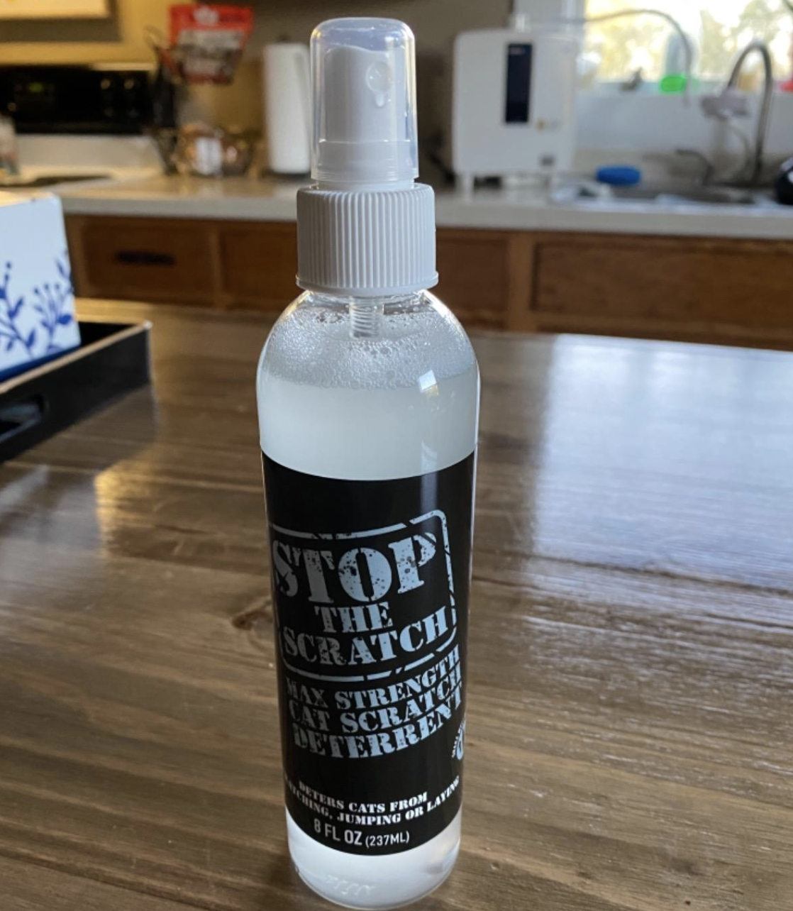 a clear bottle with a black and white label that reads &#x27;stop the scratch&#x27;