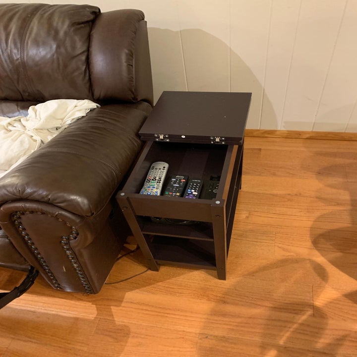 reviewer image of the inside of the dark brown HOMECHO Modern End Side Table flip top in a living room