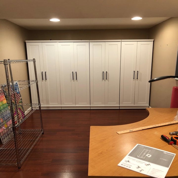 reviewer image of four soft white sauder homeplus storage cabinets side-by-side in a basement