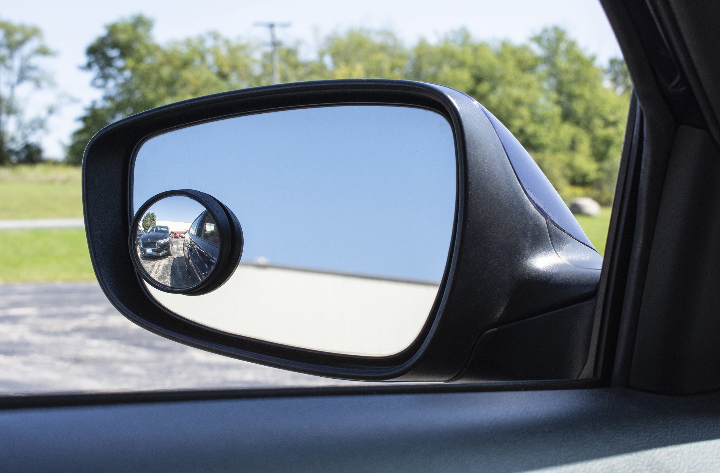 blind spot mirror on a side mirror showing a car in the blind spot