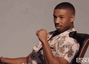A GIF of Michael B. Jordan smiling and winking