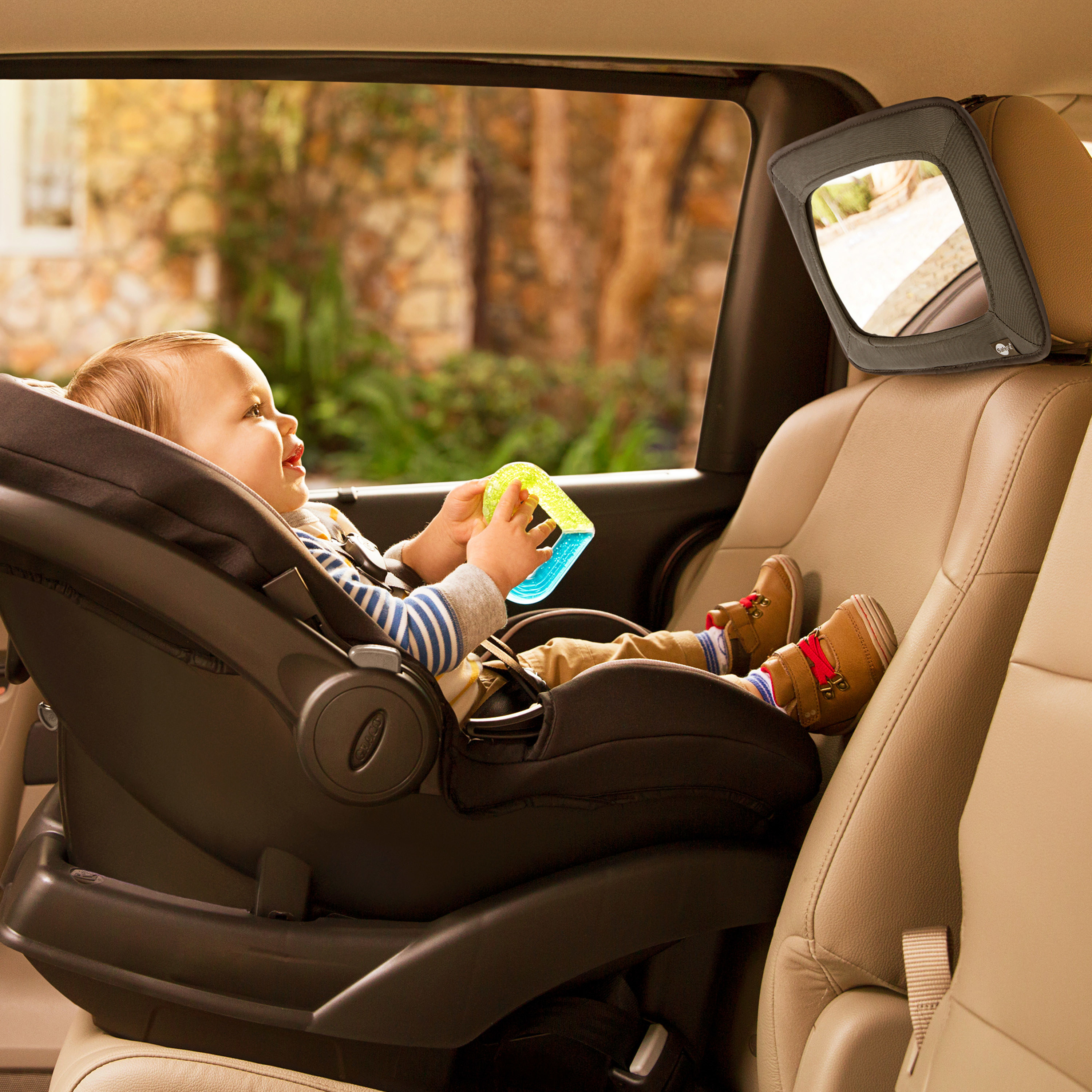 baby looking into a backseat baby car mirror