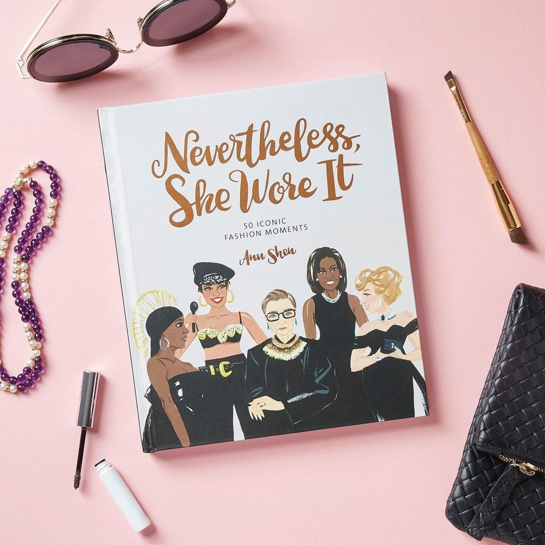 A copy of the book surrounded by beauty products and accessories