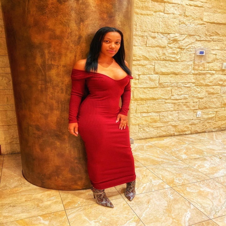 Reviewer wearing the ankle-length dress off-the-shoulder style in red