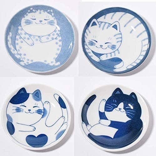 Four blue and white plates with cat illustrations 