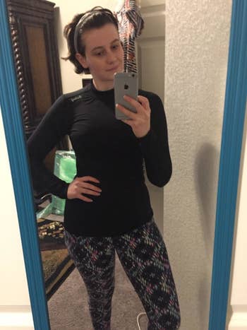 Reviewer wears black fleece thermal with patterned leggings before going out on a run