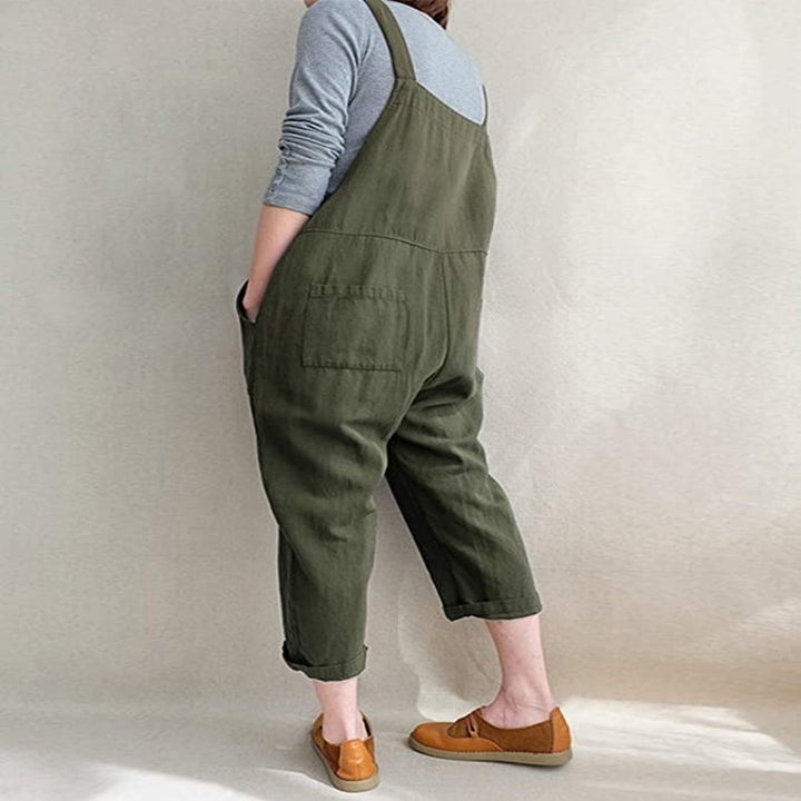 a model wearing the overalls in green