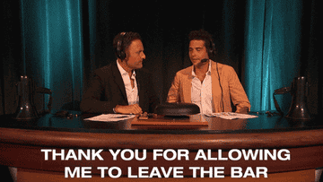 GIF of Chris Harrison and Wells hosting the wresting match