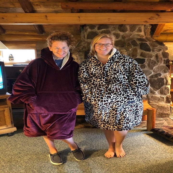 Two reviewers wearing the blanket in burgundy and leopard