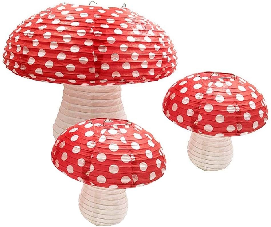 Three red top mushroom lanterns in different sizes 