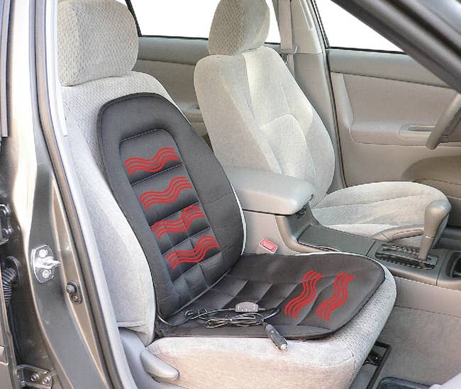 black heated seat cushion placed on a car seat