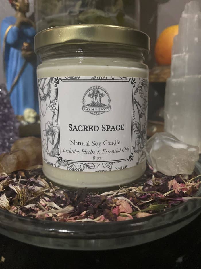 reviewer image of the art of the root sacred space candle on an altar