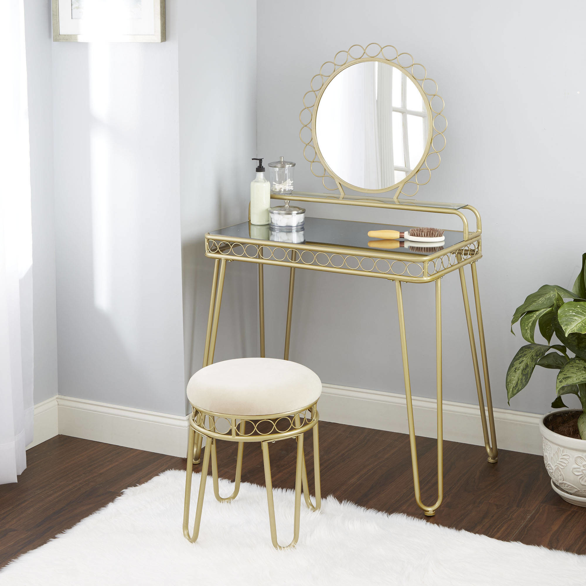 The gold and mirrored vanity table and stool