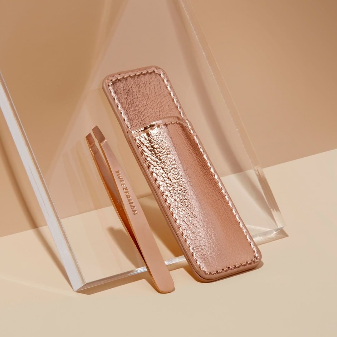 The pair of tweezers next to their case