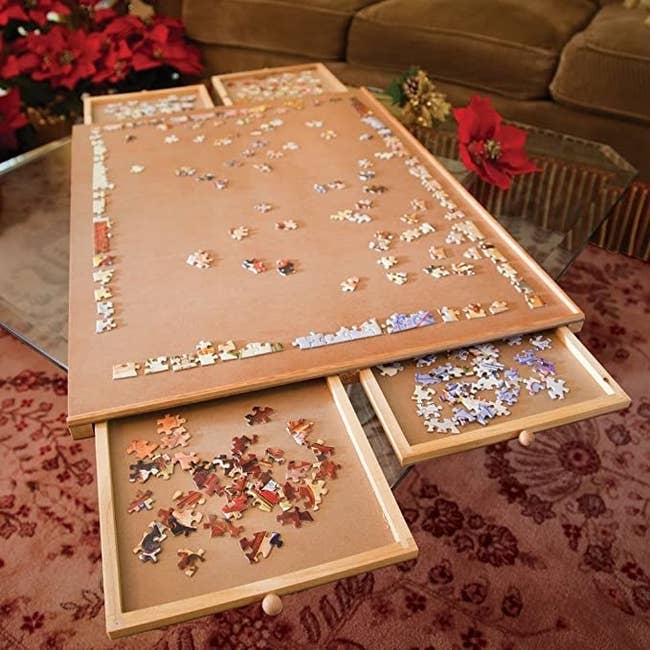 The puzzle plateau with its drawers pulled out and holding pieces