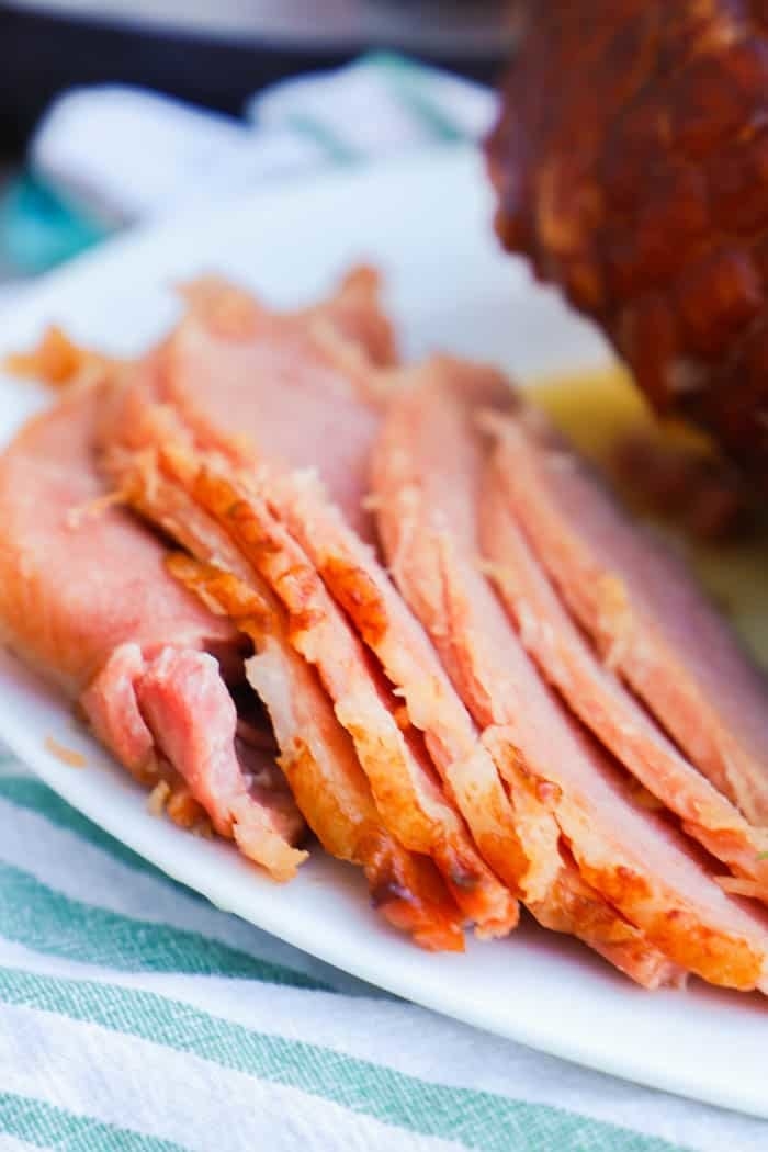 A glazed ham cut into thin slices.