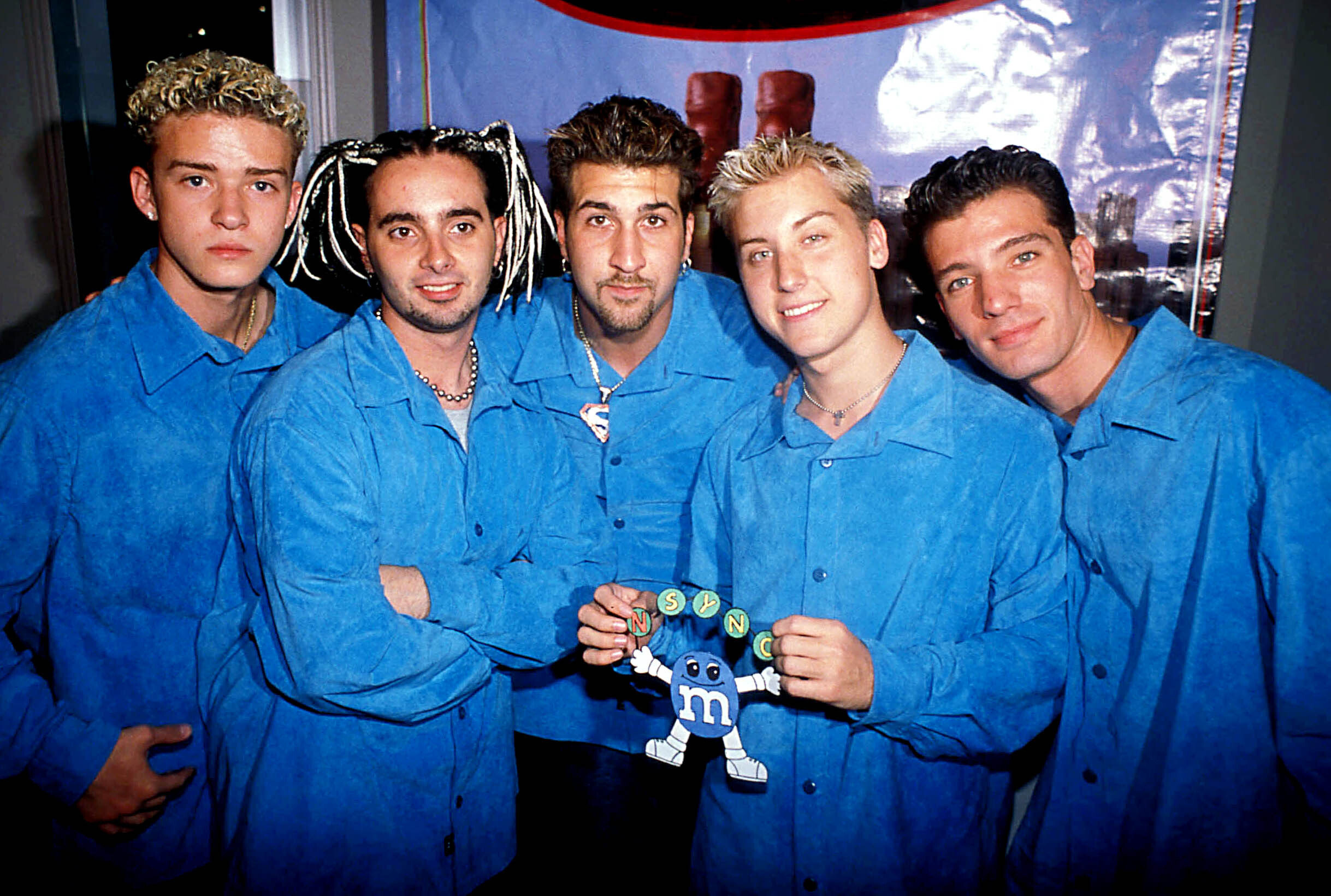 NSYNC holding an blue m&amp;amp;m dressed in blue
