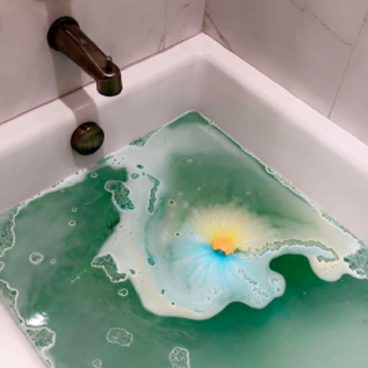 a reviewer's photo of a bath bomb in their tub